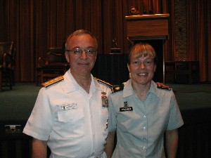 Rear. Adm. Jacob L. Shuford, USN, president of the Naval War College (l), congratulates Maj. Jill Wagner, USA, in June for her winning essay The Effects of Network-Centric Warfare on Leadership: Fresh Perspectives for the Operational Leader.